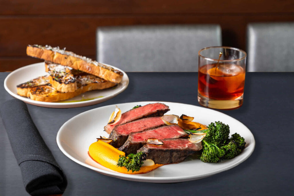 Steak, broccoli, bread and old fashioned