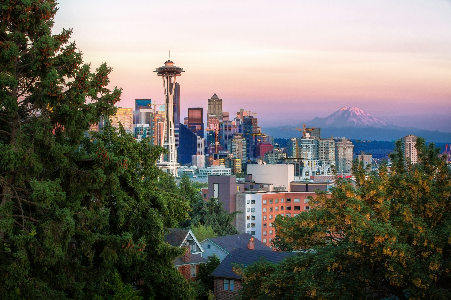 Seattle skyline featuring the Space Needle with Mount Rainier in the background.